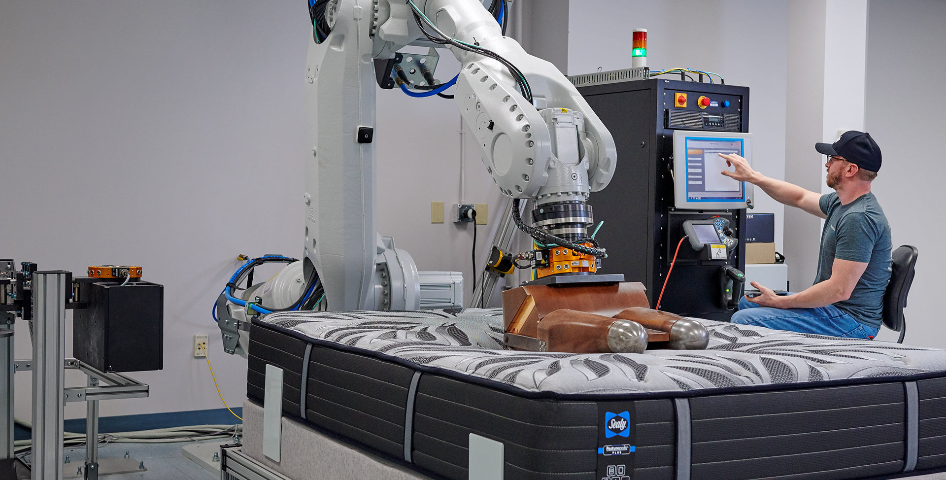 Trinity factory worker testing a Sealy&reg; mattress